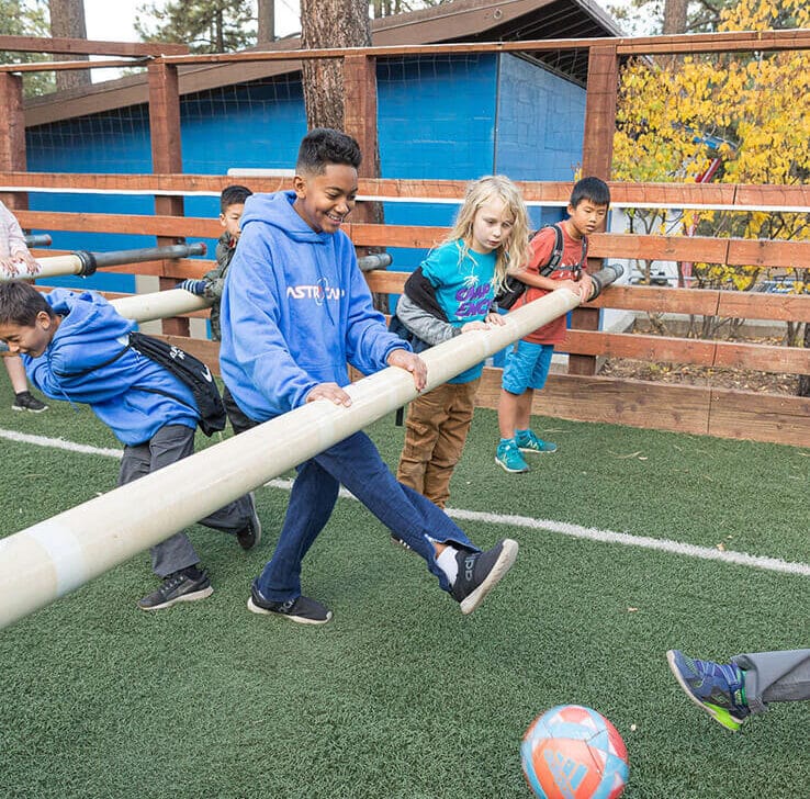 Boy kicking soccer ball.