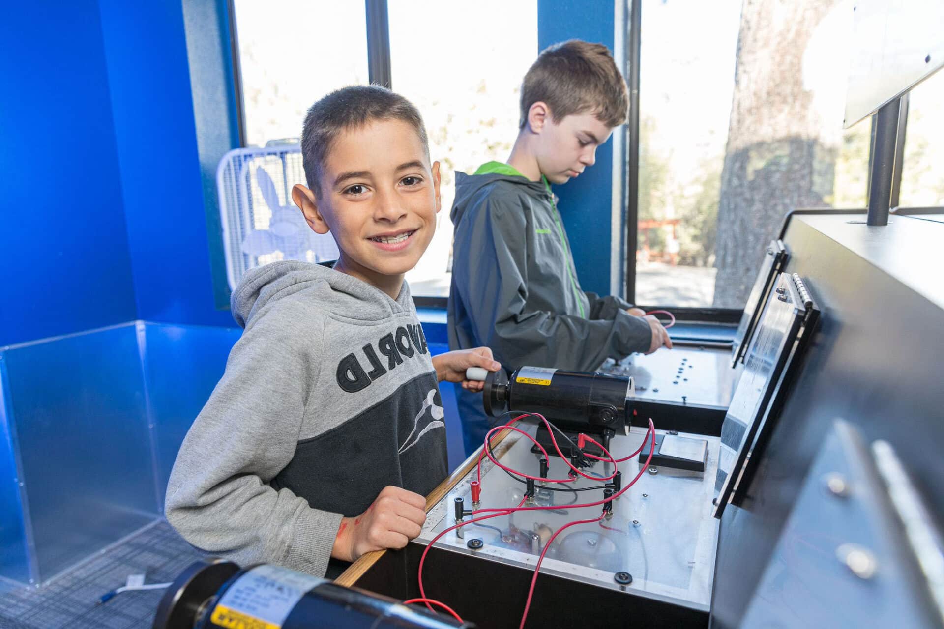 Boy smiling playing with buttons.