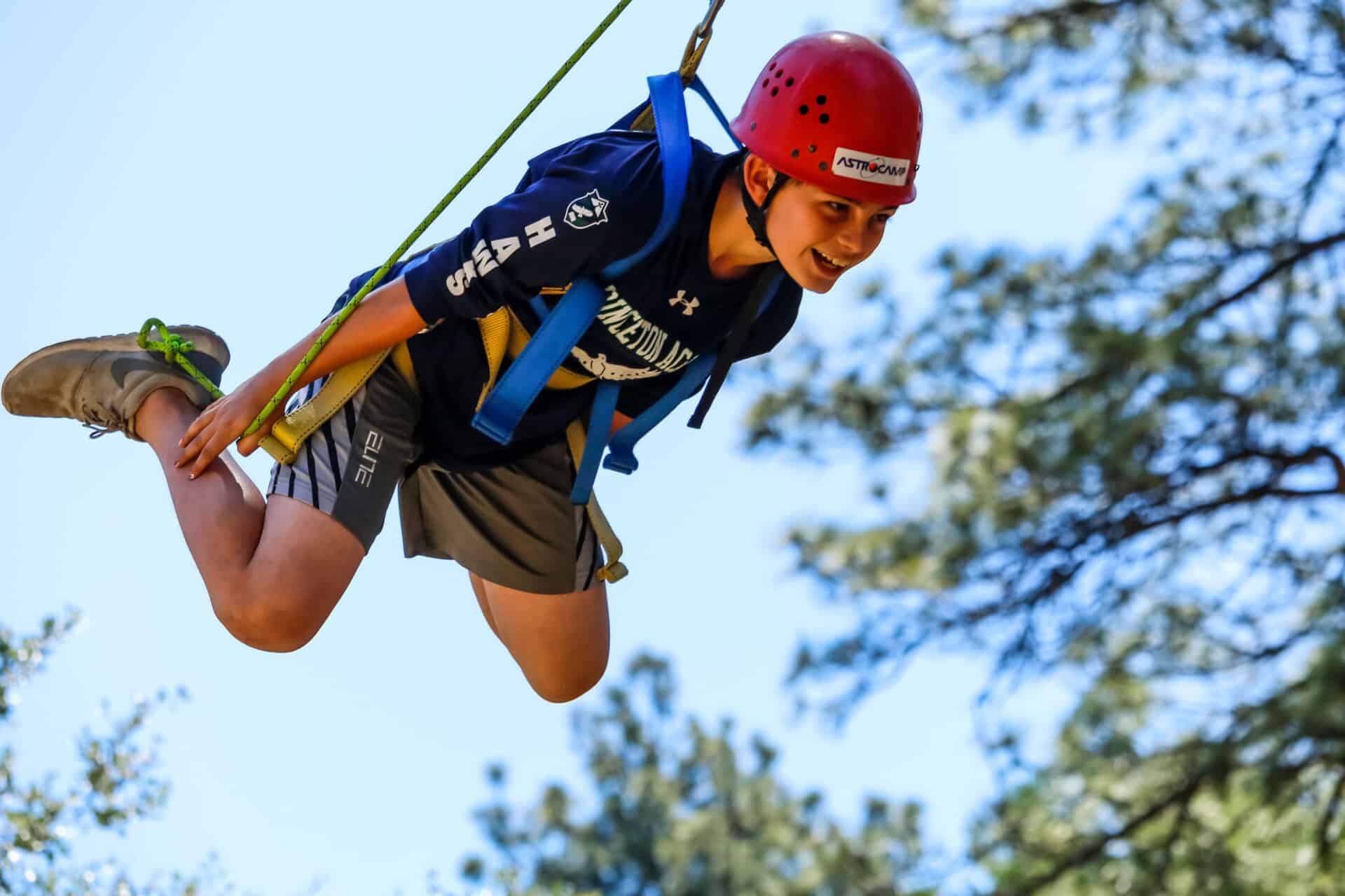 Boy smiling on zipline.