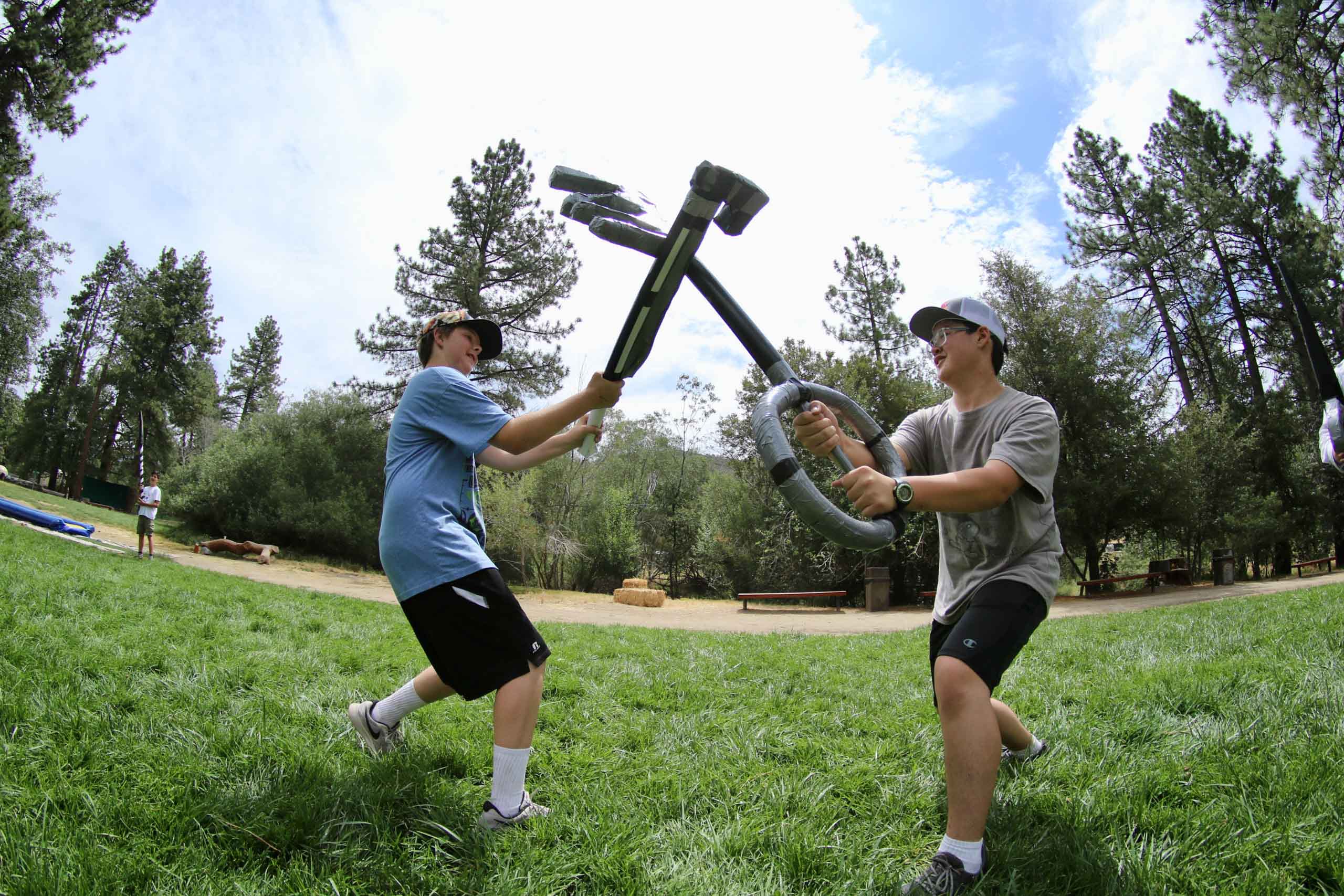 Boys fighting with swords.