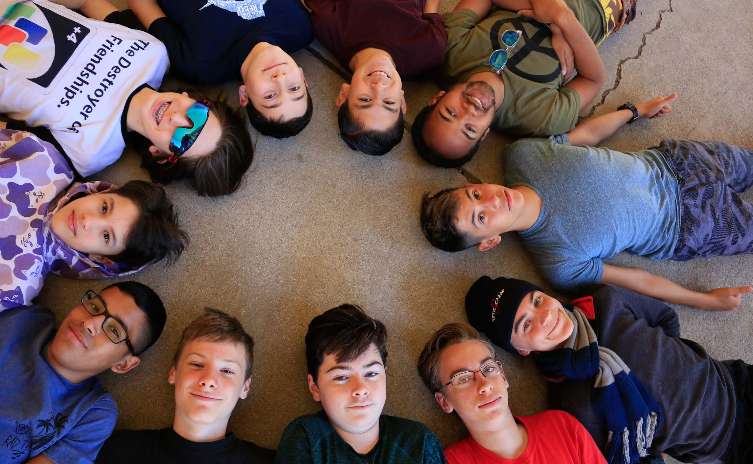 Boys posing on ground.