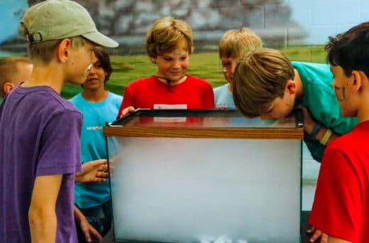 Boys looking into tank.