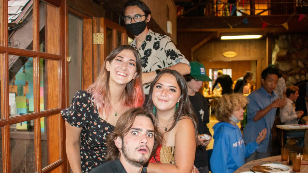 Four staff members posing in cafeteria.