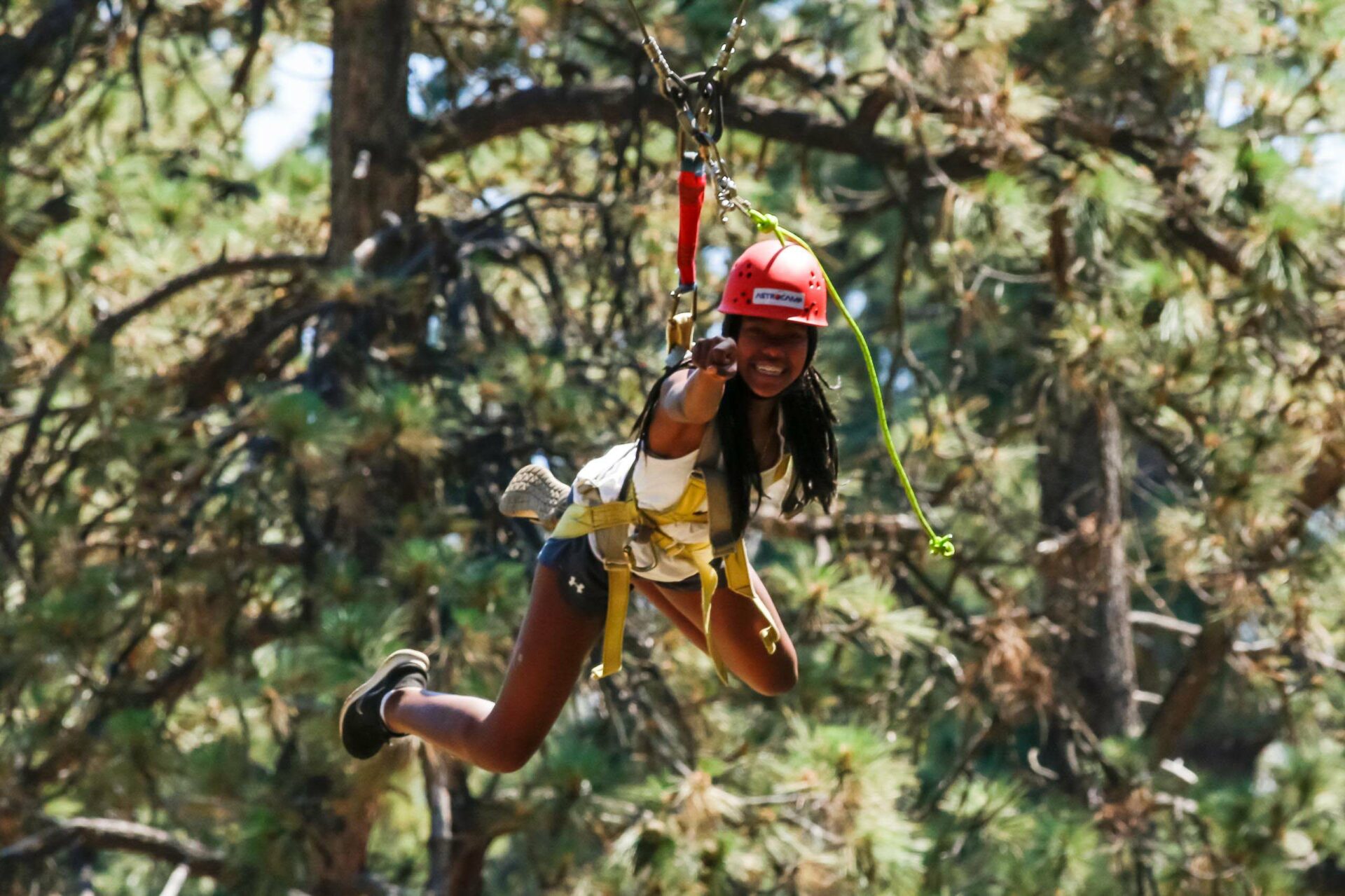 Girl pointing on zipline.