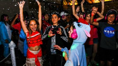 Kids in costumes cheering.