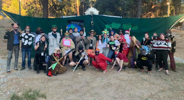 Group of people posing in costumes.