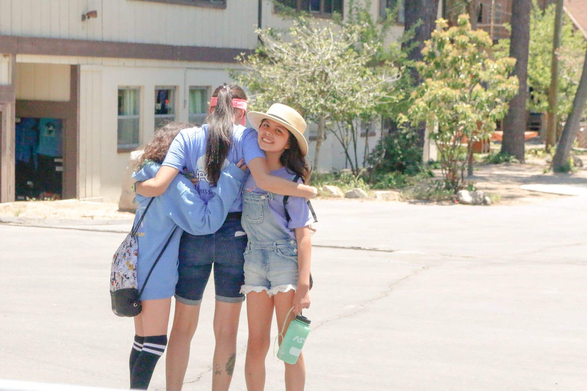 Three girls hugging.