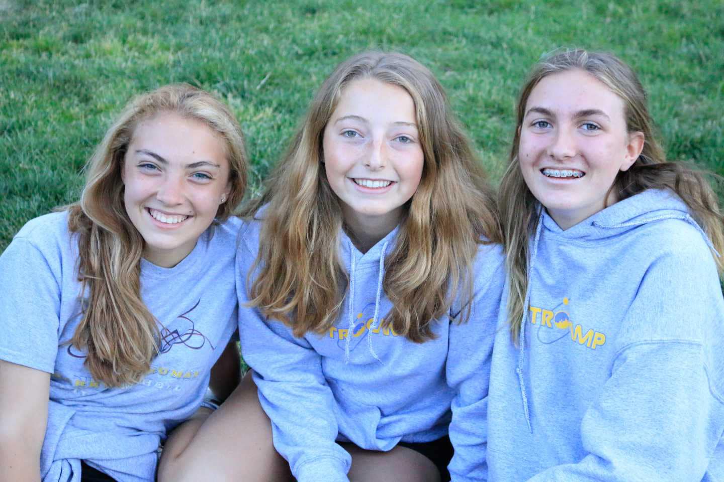 Three girls smiling.