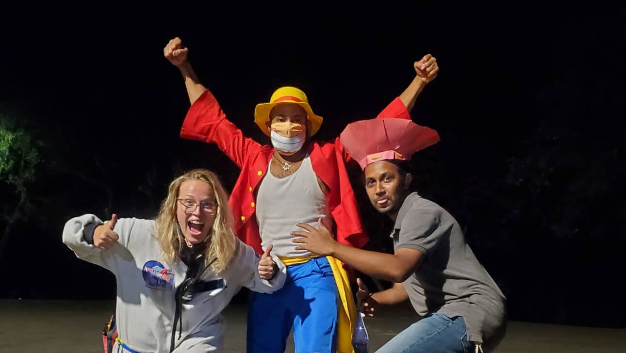 Three staff members posing in costumes.